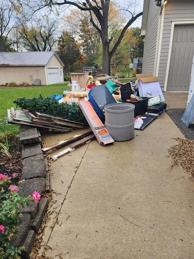 Dumpster being loaded with debris for Estate Cleanout Dumpster Rental in Colerain